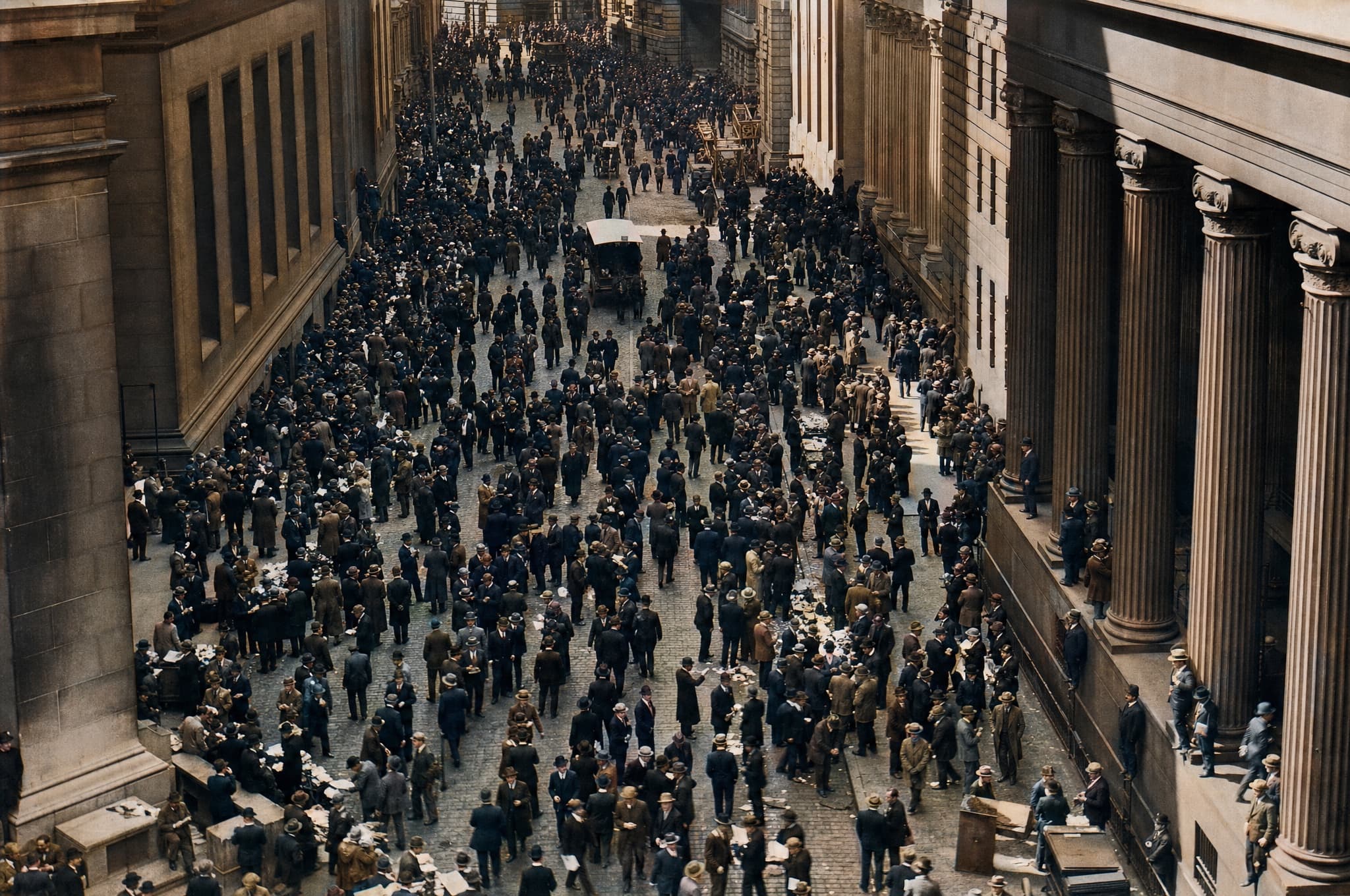 A dense curb market crowd trading between stone bank facades in Lower Manhattan